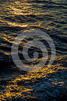 Rippled water surface at the sea during golden hour