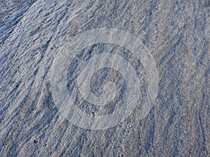 Rippled, worn and weathered gritstone rock surface