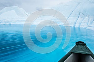 Ripples on a blue pool next to a canoe on the Matanuska Glacier