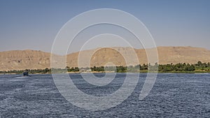 Ripples are visible on the surface of the wide blue river.