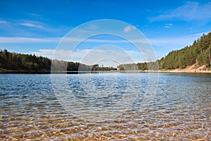 Ripples on water surface. Clear shimmering water and view at its bottom. Lake view panorama