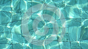 Ripples from waves on the surface of the water in the pool. Clear blue water in the pool. Top view of the water