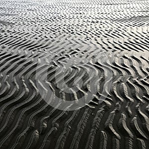 Lighting emphasizes the three-dimensional quality of the sand