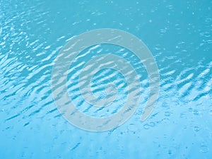 Rippling blue water by rain background