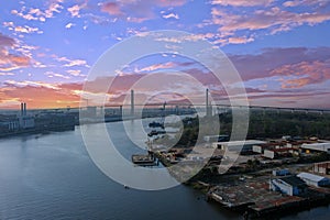 The rippling blue waters of the Savannah River with the Talmadge Memorial Bridge over the water and hotels, office buildings