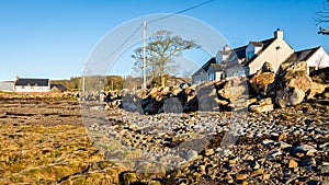 Riprap rock acting as a coastal sea defence from erosion on a cobble beach