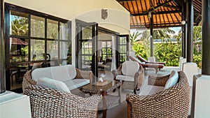 ription: A living room with a couch, two chairs, and a coffee table. The room has a modern and comfortable feel