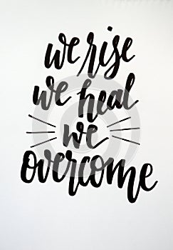 We rise, we heal, we overcome, calligraphic background