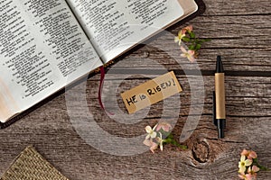 He is Risen, handwritten text quote with Holy Bible Book on wooden table, Jesus Christ resurrection concept