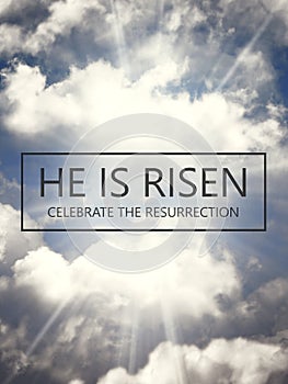 He is risen. Jesus Christ. Text over the sky with sun rays and fluffy clouds background