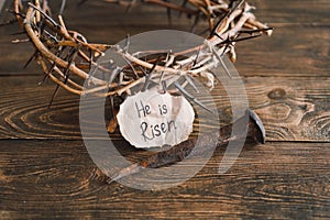 He is Risen. Jesus Crown Thorns and nails and cross on a wood background. Easter Day