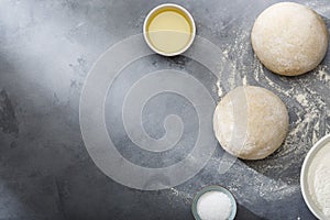 Risen or proved yeast dough for bread or pizza on a floured slate surface