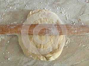 Risen or Proved Yeast Dough with Rolling Pin top view. Dough and Flour.