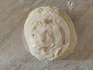 Risen or Proved Yeast Dough top view. Dough and Flour.