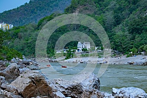 Rishikesh in India very beautiful scenery with boat in the river ganges in Rishikesh lake in the mountains of Himalayas exotic tou