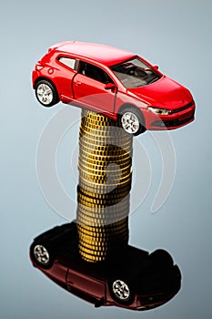 Rising car costs. car on coins