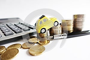 Rising cost for car running concept with miniature yellow car on stack of cash money