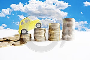 Rising cost of cars maintenance with small model car on cash stairs