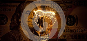 Rising electricity prices. Old light bulb and dollar bills