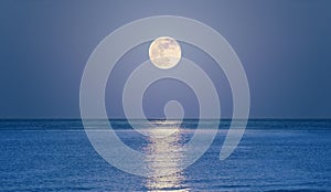 Rising moon on sea