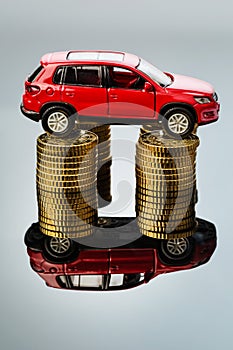 Rising motoring costs. car on coins