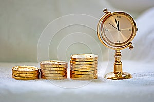 Rising pile of gold coins with a clock