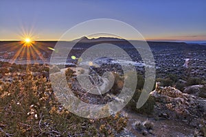 The rising sun lights up an ancient Anasazi ruin. photo