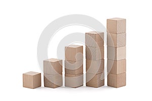 Rising wooden square blocks on white background