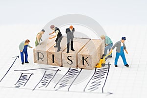 Risk assessment for business or investment, miniature figure businessman and company team standing on wooden stamp combine the