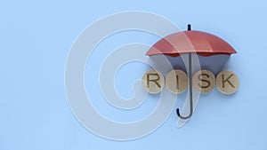 Risk assessment, management concept. Alphabet of work risk under a red umbrella