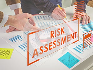 Risk assessment process concept. Colleagues with business report.