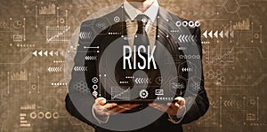 Risk with businessman holding a tablet computer