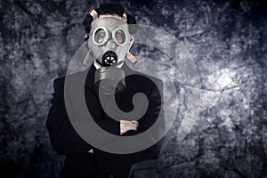 Risk concept, businessman with gas mask and black suit