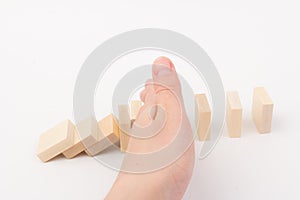 Risk concept with hand of businessman stopping and protection the domino effect