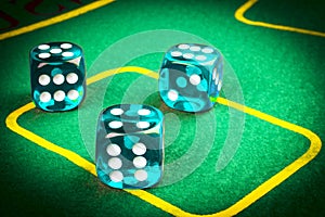 risk concept - playing dice on a green gaming table. Playing a game with dice. Blue casino dice rolls. Rolling the dice concept fo