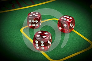risk concept - playing dice on a green gaming table. Playing a game with dice. Red casino dice rolls. Rolling the dice concept
