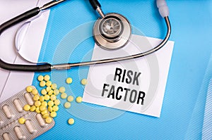 Risk factor words written on medical blue folder