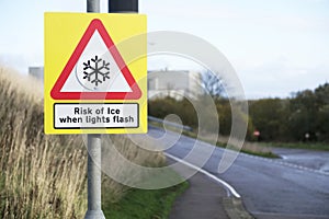 Risk of ice when light flashes winter road safety sign