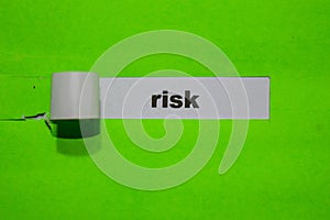 Risk, Inspiration and business concept on green torn paper