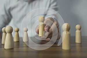 Risk management concept. A businessman pick up a wooden block while sitting in the office. Conceptual of planning, strategy. Close