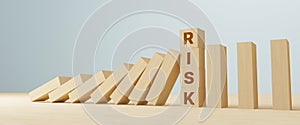 Risk management concept. Wooden block stopping domino effect for business