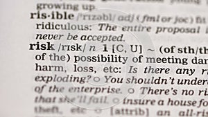Risk, pencil pointing word in english dictionary, possibility of losing assets