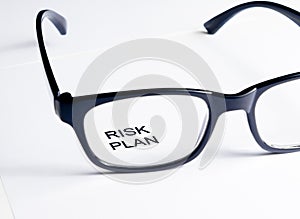 Risk plan words see through glasses lens, business concept