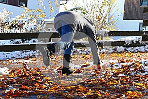 Risk of slipping in autumn and winter. A woman slipped on wet, smooth leaves