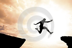 Risk and success concept of brave confident man jumping over gap
