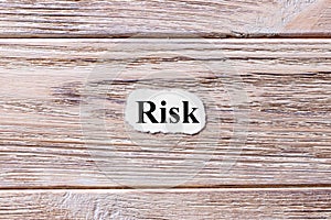 Risk of the word on paper. concept. Words of Risk on a wooden background