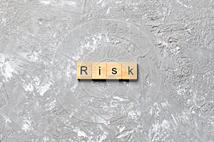 Risk word written on wood block. Risk text on cement table for your desing, concept