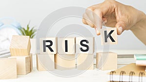 RISK word written on wooden cubes. Financial risk assessment, risk reward and portfolio risk management concept.