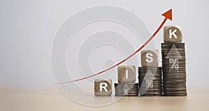 Risk wording on increase coins stacking with up arrow for financial banking risk analysis and management , High risk High return