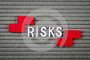 RISKS Concept. White letters of the alphabet on a green background